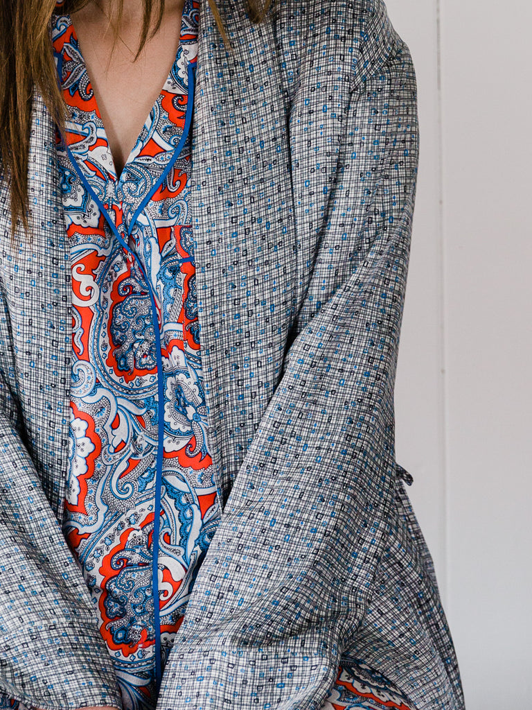 Robe with grey geometric design and long pyjama set with red and royal blue paisley design